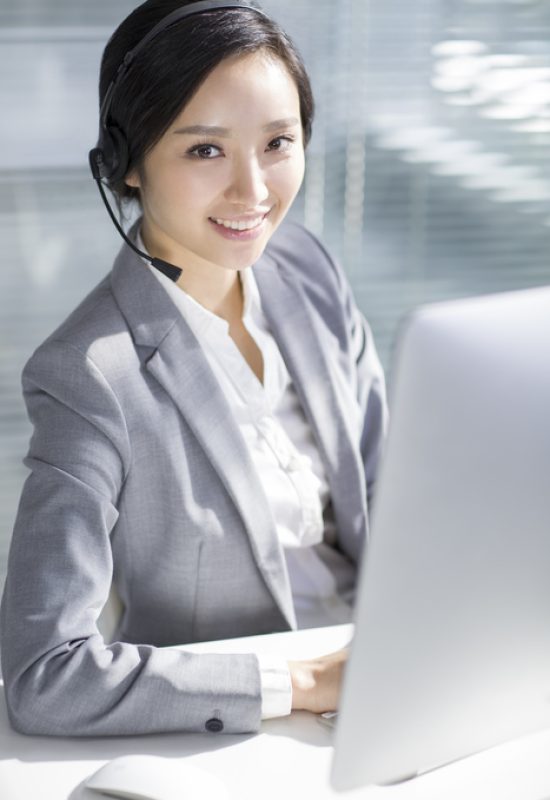 Chinese businesswoman working in office with headset