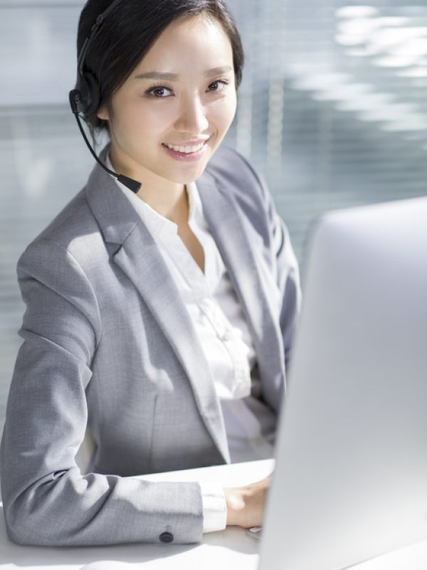 Chinese businesswoman working in office with headset